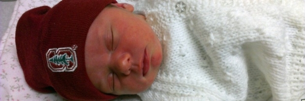 Newborn wearing a Stanford beanie